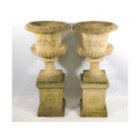 A pair of good quality Sandford Stone campana urns with plinths, 42.5in tall