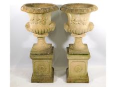 A pair of good quality Sandford Stone campana urns with plinths, 42.5in tall