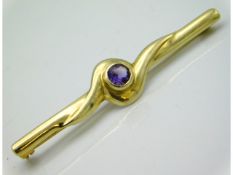 A 9ct gold bar brooch set with amethyst, 53mm wide 3.5g