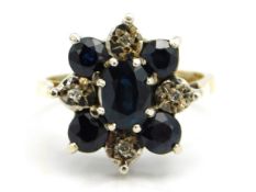 A 9ct gold ring set with diamond & five sapphires in floral arrangement, 4.4g, size M