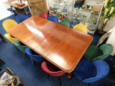 A 19thC. extending mahogany table set with twelve