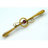 A yellow metal bar brooch, tests electronically as