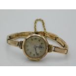 A ladies 9ct gold wristwatch & strap, running orde