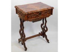 A 19thC. walnut work table with carved decor, 21.5