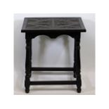 An oak lamp table with carved decor, 24in wide x 1