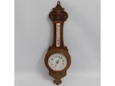 An oak barometer, thermometer has glass but end pi