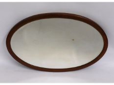 An antique oval mirror, 33in x 22in