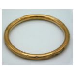 A 1920's 9ct gold bangle, 62mm diameter, 10g