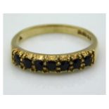 A 14ct gold half eternity ring set with sapphire,