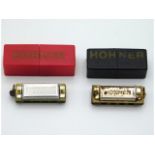 Two miniature cased Hohner harmonicas