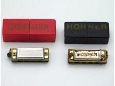 Two miniature cased Hohner harmonicas