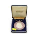 A cased Wedgwood lilac pendant with silver chain,