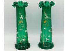 A pair of Victorian glass vases with enamelled flo