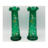 A pair of Victorian glass vases with enamelled flo