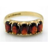 A 9ct gold five stone garnet ring, size R/S, 2.5g