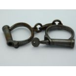 A pair of Victorian Hiatt Best handcuffs with key