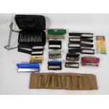 A collection of mostly Hohner harmonicas with case