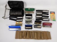 A collection of mostly Hohner harmonicas with case