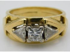An avant-garde styled 18ct gold ring set with 15pt