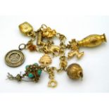 A 9ct gold charm bracelet with gold & silver charm