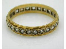 An 18ct gold eternity ring, lacking one diamond, s