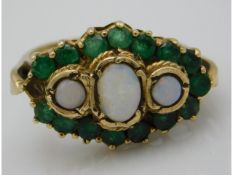 A 9ct gold ring set with emerald & opal, loss to o
