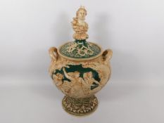 A large, decorative continental majolica jar with