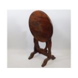 A 20thC. stained hardwood tilt top table, 24in dia