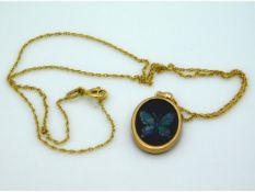 A 9ct gold chain & pendant with inlaid opal butter
