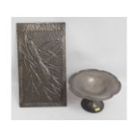A decorative pewter plaque with relief bird decor,