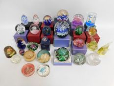A quantity of mostly glass paperweights twinned wi