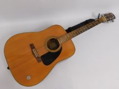 A Fender DG-3 acoustic guitar with strap, some lig