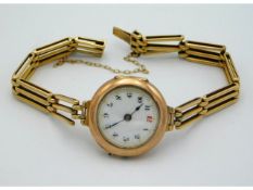 An antique gold ladies wrist watch, strap 15ct gol
