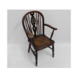 An oak framed wheel back arm chair with elm seat