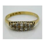 An antique 18ct gold ring set with twelve small di