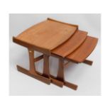 A large retro teak nest of tables, some play in on