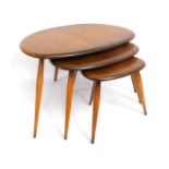 A retro nest of three Ercol elm 'pebble' tables