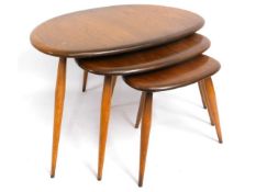 A retro nest of three Ercol elm 'pebble' tables