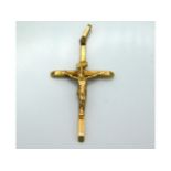 A yellow metal crucifix, tests electronically as 9