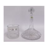 A cut glass crystal ships decanter twinned with a