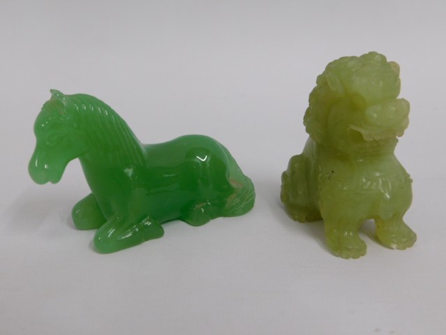 A carved Chinese jade horse twinned with a carved