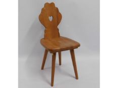 An oak hall chair with carved heart aperture to sp