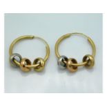 A pair of hoop earrings set with three colour gold