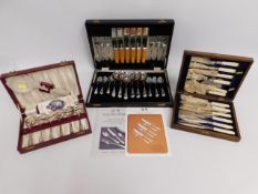 Three boxed cutlery sets including a resin handled