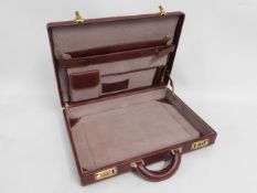 A leather brief case, 18in wide x 13.5in deep x 3i