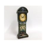 A decorative German faience clock, signed Dec: E.