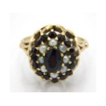 A 9ct gold garnet & pearl cluster ring, 4.7g, size