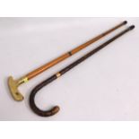 A three piece brass handled walking cane in the fo