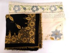 An embroidered bed spread twinned with a decorativ