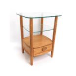 An Ercol light elm & glass occasional table, 25.25in tall